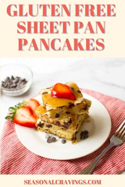 A stack of gluten-free sheet pan pancakes topped with strawberries and syrup on a white plate. A bowl of chocolate chips and a strawberry are on the side. Text reads "Gluten Free Sheet Pan Pancakes".