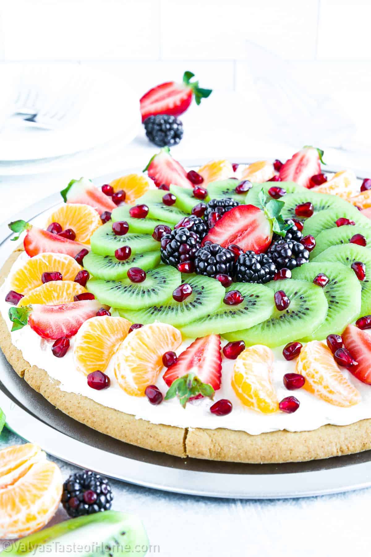 A unique pizza with fruit on it.